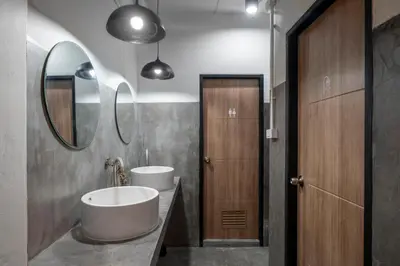 a bathroom with two sinks and a large mirror at Kuha Phuket Old Town in Phuket Town
