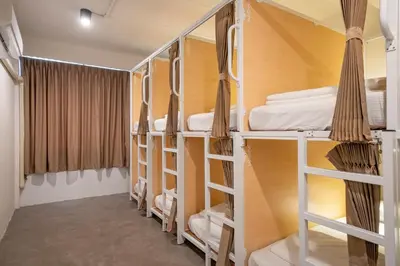 a room with bunk beds in a hostel at Kuha Phuket Old Town in Phuket Town