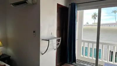 a door to a balcony with a view of the beach at PP Insula in Phi Phi Don