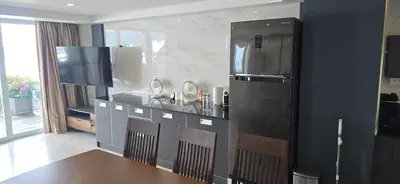 a kitchen with a black refrigerator and a table at Andaman Seaview house rooftop in Patong Beach