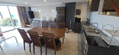 a kitchen with a wooden table and chairs in it at Andaman Seaview house rooftop in Patong Beach