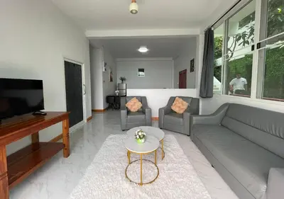 a living room with a couch and a table at Amazing Seaview 2-Bedroom House in Patong in Patong Beach