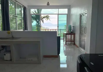 a living room with a fireplace and a large window at Amazing Seaview 2-Bedroom House in Patong in Patong Beach
