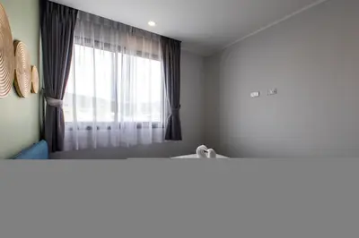 a room with a window and a bed with at Classic Studio Apt T3-329 in Chalong