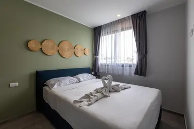 a bedroom with a bed with hats on the wall at Classic Studio Apt T3-329 in Chalong