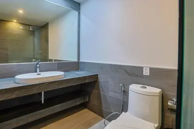 a bathroom with a white toilet and a sink at Pool View 1 Bed Apt T2-620 in Chalong