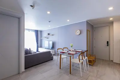 a living room with a table and a couch at Pool View 1 Bed Apt T2-620 in Chalong