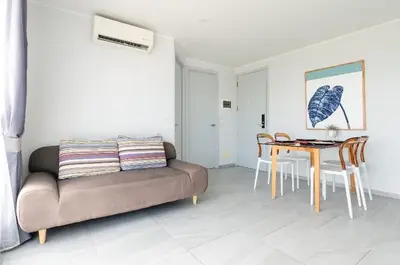 a living room with a couch and a table at Sleek 2 Bed Apt T2-818 in Chalong