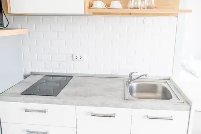 a kitchen with a sink and a counter top at Sleek 2 Bed Apt T2-818 in Chalong