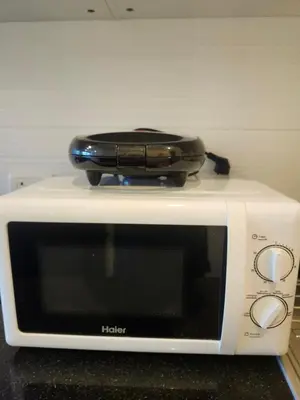 a microwave with a suitcase on top of it at veloche group 2 in Karon Beach