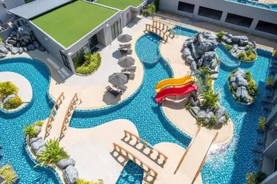 an aerial view of a resort pool with a water park at Duplex in NaiHarn Residence near the Beach, UTL B325 in Rawai Beach