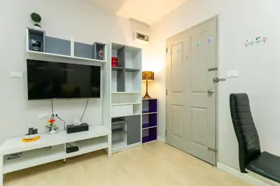 a living room with a tv and a white entertainment center at Tony DCondo in Kathu