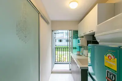 a kitchen with a door leading to a balcony at Tony DCondo in Kathu