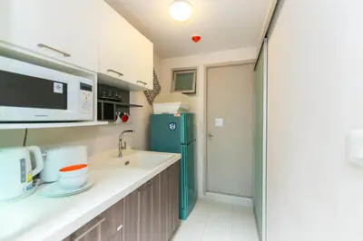 a kitchen with a sink and a green refrigerator at Tony DCondo in Kathu
