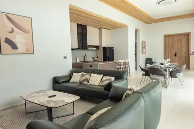 a living room with a couch and a table at Mouana Breeze Maikhao VIP 4-bedroom Pool Villa 9915 in Mai Khao Beach