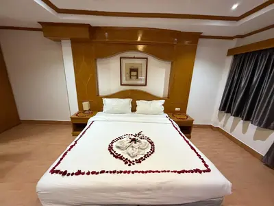 a bedroom with a large white bed with a heart made up at Beach Comber in Patong Beach