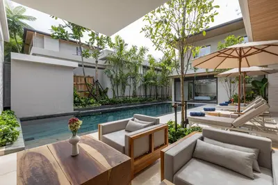 an outdoor living room with a pool and a villa at Layana Residence in Layan Beach