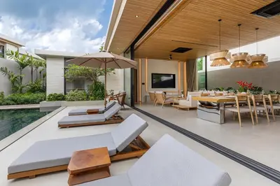 an open living room with a pool and dining room at Layana Residence in Layan Beach