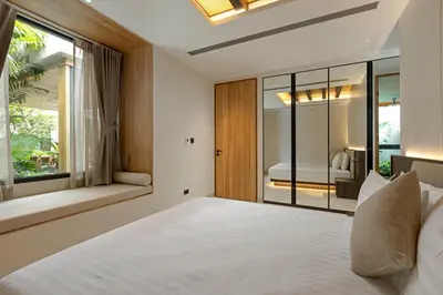 a bedroom with a large bed and a window at Layana Residence in Layan Beach