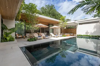 a swimming pool in the backyard of a house at Layana Residence in Layan Beach