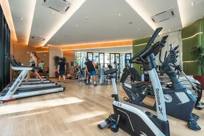 a gym with tread machines and people in the gym at C175 Stylish Condo with Pool View D Condo Phuket in Kathu