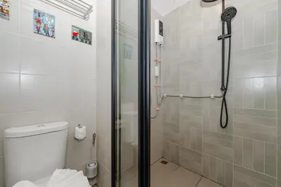 a bathroom with a shower with a toilet and a glass shower at C175 Stylish Condo with Pool View D Condo Phuket in Kathu