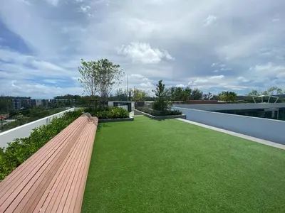 a garden on the roof of a building with green grass at Apartment at Skypark Laguna next to golf course in Bang Tao Beach