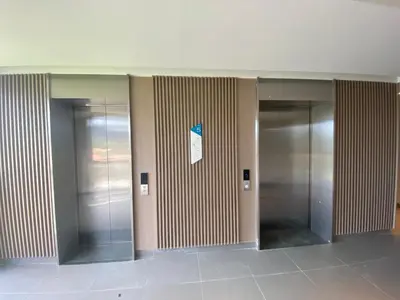 a hallway with three elevators in a building at Apartment at Skypark Laguna next to golf course in Bang Tao Beach