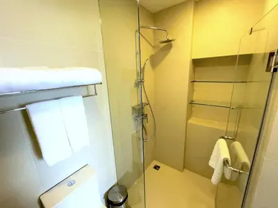 a bathroom with a shower with a glass door at Apartment at Skypark Laguna next to golf course in Bang Tao Beach