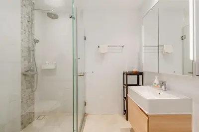 a white bathroom with a sink and a shower at C176 Diamond Paradise Getaway Condo Phuket in Bang Tao Beach