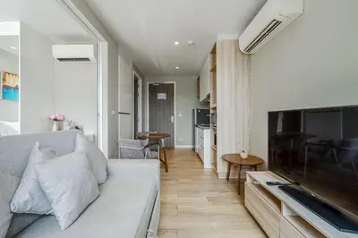 a living room with a couch and a flat screen tv at C176 Diamond Paradise Getaway Condo Phuket in Bang Tao Beach