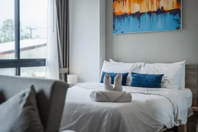 a bedroom with a bed with two stuffed animals on it at C176 Diamond Paradise Getaway Condo Phuket in Bang Tao Beach