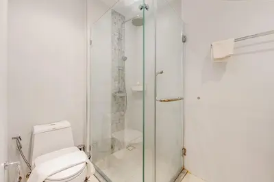 a bathroom with a toilet and a glass shower at C176 Diamond Paradise Getaway Condo Phuket in Bang Tao Beach