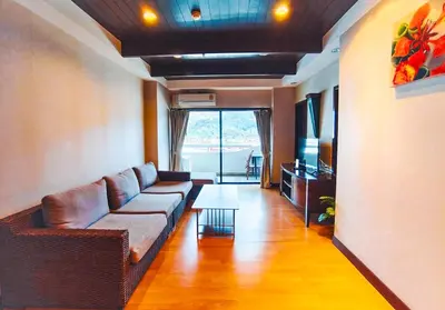 a living room with a couch and a table at Patong Tower in Patong Beach