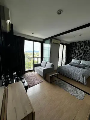 a bedroom with a bed and a couch and a balcony at Top Floor Condo Mountainview, 5min to beach, Bangtao Phuket in Bang Tao Beach
