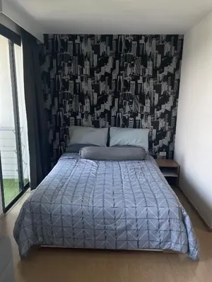 a bedroom with a bed with a black and white comforter at Top Floor Condo Mountainview, 5min to beach, Bangtao Phuket in Bang Tao Beach