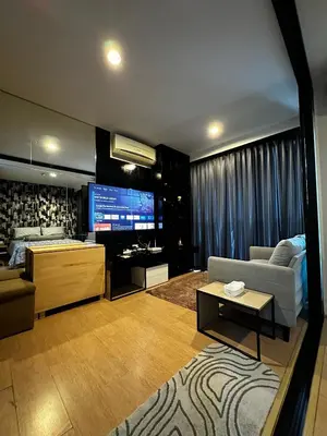a living room with a couch and a tv at Top Floor Condo Mountainview, 5min to beach, Bangtao Phuket in Bang Tao Beach