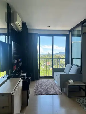 a living room with a couch and a large window at Top Floor Condo Mountainview, 5min to beach, Bangtao Phuket in Bang Tao Beach