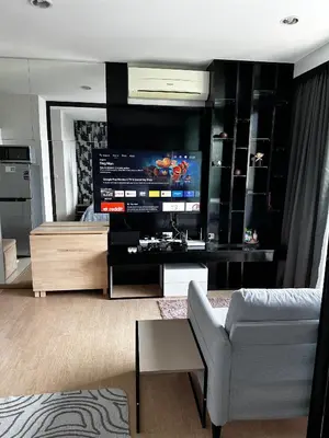 a living room with a large television and a couch at Top Floor Condo Mountainview, 5min to beach, Bangtao Phuket in Bang Tao Beach