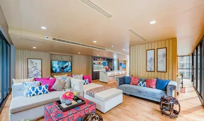 a living room with two couches and a table at The Base Central Phuket-B20W in Ban Rangeng