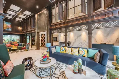 a living room with a blue couch and a table at The Base Central Phuket-B20W in Ban Rangeng