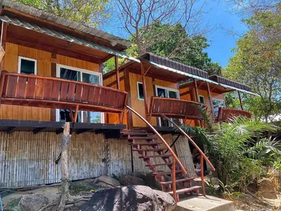 a wooden house with stairs leading up to it at Phuphaya Seaview Adults Only in Phi Phi Don