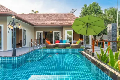 a villa with a swimming pool and a house at V269 Yamu Sunset Villa 3BR Sea View Pool Retreat in Ban Bang La