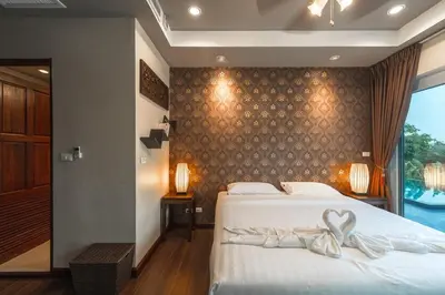 a bedroom with a bed with a bow on it at V269 Yamu Sunset Villa 3BR Sea View Pool Retreat in Ban Bang La