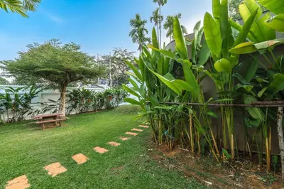 a garden with a bench and some green plants at V269 Yamu Sunset Villa 3BR Sea View Pool Retreat in Ban Bang La