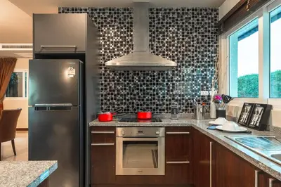 a kitchen with a stainless steel refrigerator and a stove at V269 Yamu Sunset Villa 3BR Sea View Pool Retreat in Ban Bang La