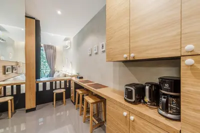 a kitchen with wooden cabinets and a counter top at C179 Serene and Stylish Getaway in Kamala, Phuket in Kamala Beach