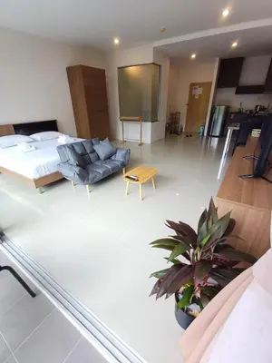 a living room with a bed and a couch at Chic Condominium in Karon Beach
