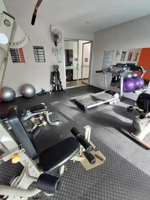 a gym with treadmills and machines in a room at Chic Condominium in Karon Beach