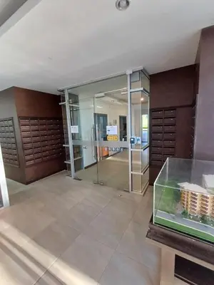 a large room with a glass shower in a building at Chic Condominium in Karon Beach